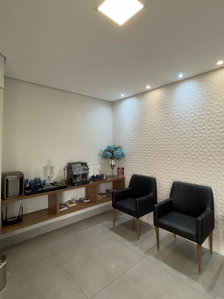 Sala de espera com poltronas e cantinho do café